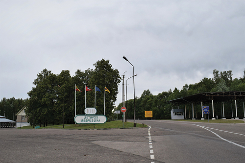 Figure 1. The Polish-Lithuanian border crossing with the visible entrance to Lithuania, the official sign ‘the Republic of Lithuania’ on the left and the sign of the EU on the right of the road. © [Gintarė Kudžmaitė].