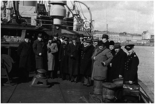 Figure 3. Public officials, diplomats and naval officers aboard icebreaker ‘Sisu’ in Helsinki South Harbour in front of the presidential palace during the Second World War. Source: © [Unknown photographer, Henrik Ramsay Private Archive, free under Finnish Copyright law 49 a § 8.7.1961/404]. Reproduced with the permission of the Finnish National Archives.