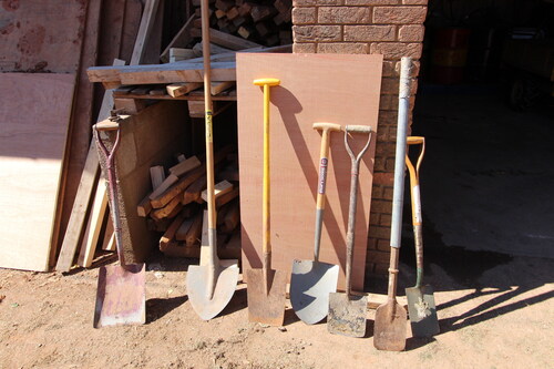 FIG. 1 Tools used for digging out graves. Several of these have been modified, for example by the addition of elongated handles.