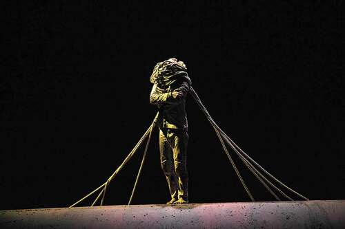 Image 3. Akram Khan piles on the wires over his head to obscure his identity and represent the million plus Indian colonial soldiers in WW1. In XENOS by Akram Khan Company at Onassis Cultural Centre, Athens, February 2018. Photo: Jean-Louis Fernandez.