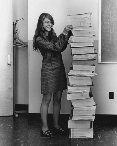 FIGURE 7 Margaret Hamilton standing beside the stacks of software listings she and her MIT team developed for the Apollo Project. Hamilton was the Director of the Software Engineering Division at the MIT Instrumentation Laboratory, which was responsible for creating the onboard flight software for the Apollo spacecraft. This image is in the public domain, published in the United States without a copyright notice, and digitally restored by Adam Cuerden. The original version of this photograph dates back to 1 January 1969.