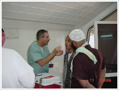 Figure 1. Ziad Memish at Mecca during Hajj 2008 taking throat swabs from a Muslim pilgrim.