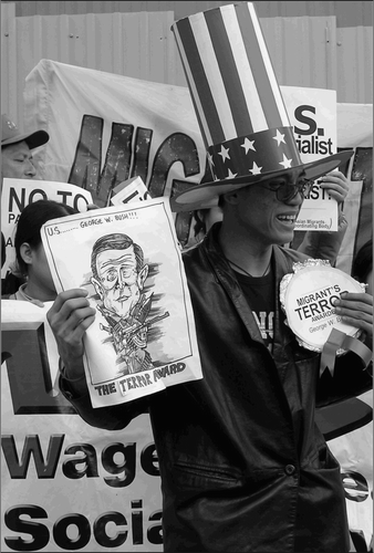 Fig. 5. During the Consulate Hopping Protest and Hall of Shame Awards demonstration in 2005, a migrant worker serves as a stand-in for President George W. Bush, who is presented with the “Terror Award.”