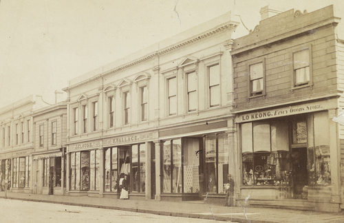 Figure 9. George Street c1870s, showing Andrew Lee’spaperhanging business to the left of Lo Keong’s fancy goods store. Photographer: Unknown. Source: Hocken Collections - Uare Taokao Hākena, University of Otago, P1911-001-011a.