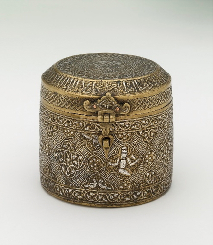 Figure 5. A Cylindrical Box circa 1233–1259 attributed to Mosul, cast (main body) and sheet brass (lid) with inlaid silver and black bituminous paste, 11 cm x H: 10 cm, Courtesy the Trustees of the British Museum.