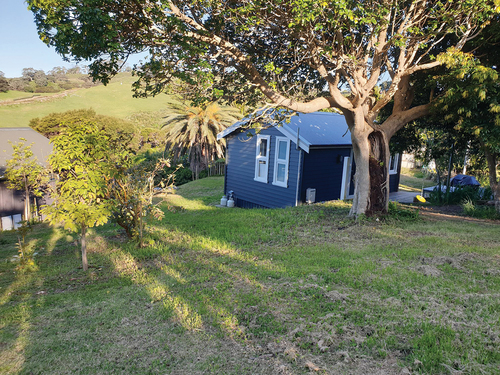 Figure 1. (a) is a small bach or holiday house. An example of a traditional Waiheke Island bach.Credits: The credit for the figure is Brian Bookman.