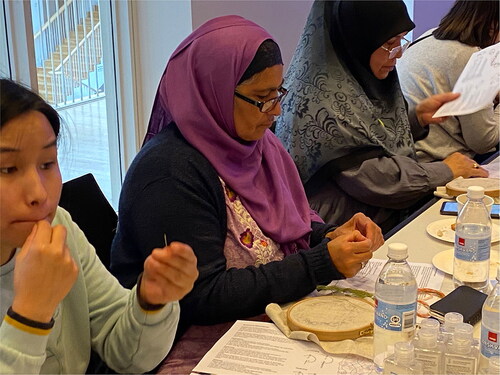 Figure 2 Sunday Pursuits textile craft event, on October 24, 2021, with the theme of embroidery, The National Museum of Denmark. Rubina Shaheen (left) and Samera Jamill enjoyed working with the old motifs from the Viking Age cloak found in a grave at Mammen, Denmark. On the same day, the group visited the exhibition The Raid, telling the story of the Vikings who raided locations as far away as the Mediterranean Sea and Central Asia. Photo: Gitte Engholm.