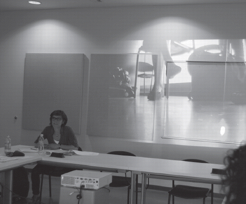 Sylvia Tourangeau, Victoria Stanton, K. G. Guttman and Tagny Duff at a Trans-Montréal planning meeting, 8 May 2013, at Concordia University (picture taken showing Amelia Jones presenting, with footage from roving video projected on the wall behind her)