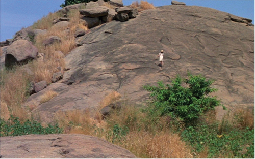 Figure 5. The child France ascending a rocky outcrop going up a rock formation in Cameroon (Chocolat).