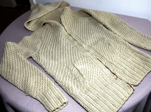 Figure 2. Knitted cardigan made by Beatriz on display at the Crafting Resistance exhibition.