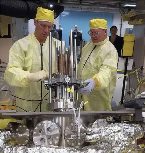 Fig. 4. Installation of interference rings to clamp the eight heat pipes to the highly enriched uranium fuel.