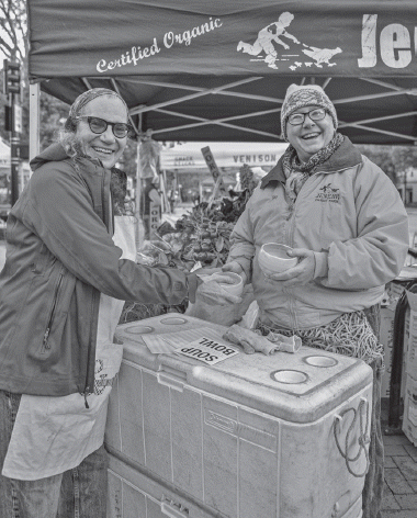 Kay Jensen (pictured right) receives a gift from Laurie Beth Clark (pictured left), Michael Peterson, and Grant Gustafson. Soup:Bowl – a table to farm project. Photo Maryam Ladoni