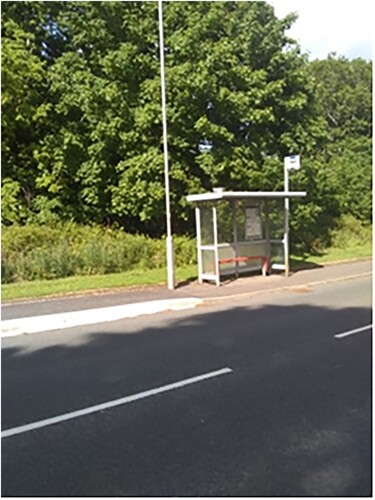Image 2. The empty bus: fearing the familiar (R6). This image of a bus stop was taken by the participant showing a bus stop close to her home. The bus shelter is located in the countryside, and you can see the shadow of the trees from the other side of the road. The image is taken focussing on the bus shelter and the direction of travel. The shadows from the trees give a sinister feel to the image even though the sun is shining on the bus shelter. There is a contrast between the familiarity of the shelter in sunshine and the road, indicating travel which is in shade.