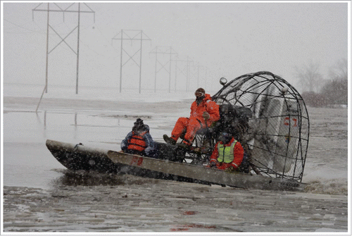 Figure 2. In Fargo, North Dakota, the spring flood threat involves overland flooding at a time of sub-freezing temperatures and periodic blizzard conditions. Search and rescue teams patrol the frozen Red River of the North. Source: Cass County, N.D., March 30, 2009 –Cass County Sheriff's Dept., US. Fish and Wildlife and local Search and Rescue volunteers check on isolated residents in remote farm communities along the Wild Rice river. Photo by Andrea Booher/FEMA - Location: Cass County, ND. http://www.fema.gov/media-library/assets/images/55209.