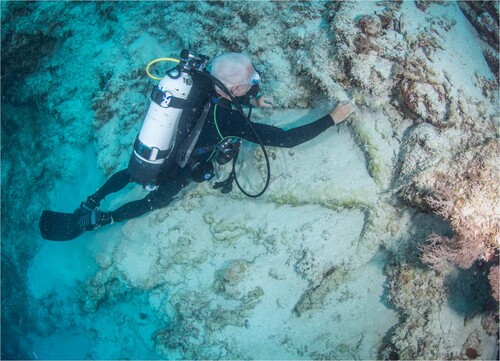 Figure 8. Kieran Hosty (ANMM) with the old pattern long-shanked Admiralty anchor (A1) found in deep water off the reef’s western edge (photo: Julia Sumerling).