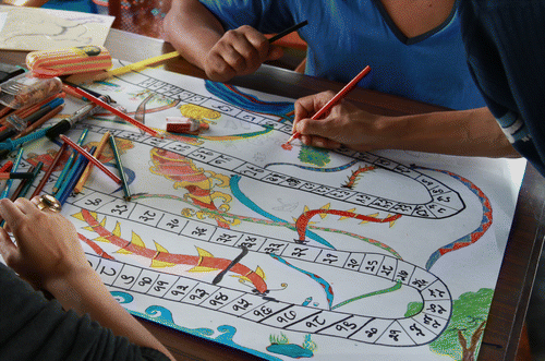 Figure 1. Project participants designing the Nags and Makars board game (based on Snakes and Ladders) (Aggett, Citation2015a).