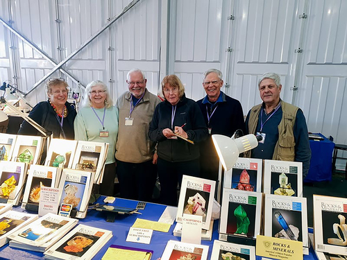 At the La Fuente Show in Tucson, Ludmila Cheshko (left); (from right): Michael Leybov, Carl Francis, Diane Francis, and Terry Huizing.Volunteers representing Rocks & Minerals at various shows.