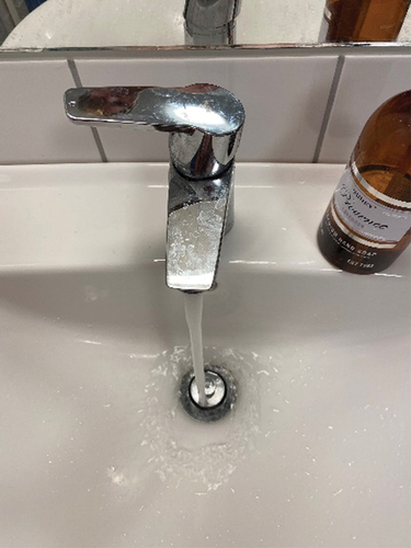 Figure 4. Picture of bathroom sink with running water from the tap and the tap handle turned as far as possible in the direction of ‘only hot tap water’. (image by Sven).