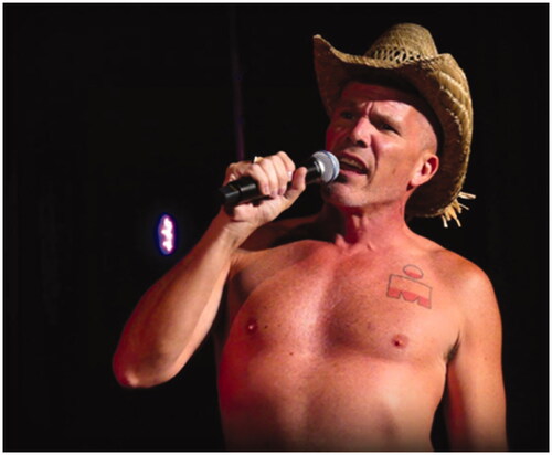 Figure 4 DMGMC member at a concert wearing a cowboy hat and performing shirtless. Courtesy of the DMGMC.