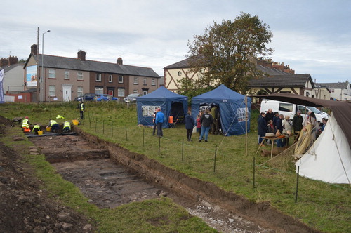 Figure 7. Typical morning scene at Pentre Ffrwndan. Excavation in progress, with visitors at the ‘ask the expert’ drop-in tents and re-enactors’ displays. Photo: CPAT 4564–0032 © CPAT.