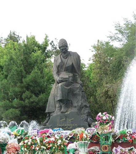 Figure 2. Statue of Magtymguly, with floral decorations placed for the “Days of Magtymguly Poetry” celebrations (May 2013) (from Taylor Citation2014a, 5). Sculptors: V.N. Vysotin and V.G. Kutumov; design by V.V. Popov. Statue erected in May 1971 on Magtymguly Shayoly Street in Ashgabat, Turkmenistan. Basalt. Inscription on base of statue (Turkmen in Cyrillic script) reads “Magtymguly;” Cyrillic letters have been modified to appear similar to Turkmen written in Arabic script of the kind Magtymguly would have used.