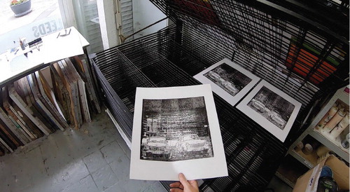 Figure 6. Placing a print in the communal drying rack.