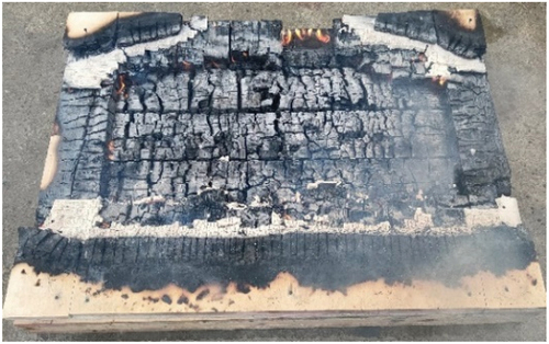 Figure 18. A photo was taken after the test showing the fall-off of cladding and outer layer of CLT panel: W-12.5FP25PW.