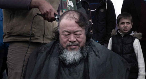 Figure 3. Being with refugees: Ai receives a haircut in a refugee camp.