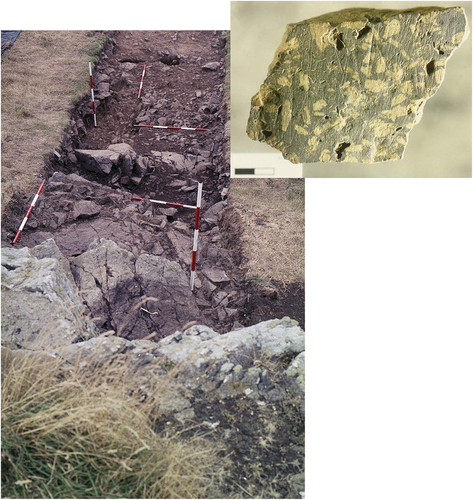 Figure 1. A mid-excavation view of Cutting 11 standing on top of the quarried porphyritic andesite outcrop (foreground) and looking west. Top right is a quarried fragment of porphyritic andesite preserving the original glacially striated exterior surface of the outcrop.