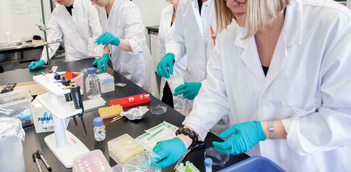 Figure 3. Textile designers learning lab procedures of synthetic biology. Photo by Eeva Suorlahti