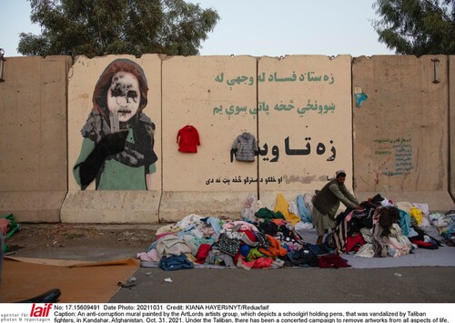 Figure 6. Anti-corruption mural painted by the ArtLords artists groups with a school girl holding pens that was vandalized by Taliban fighters in Kandahar, Afghanistan. (Photo by Kiana Hayer New York Times Redux/Laif).