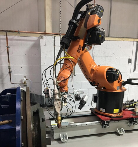 Figure 21. Robotic LMD setup integrated by CNC Robotics Ltd. Robot is mounted on a linear motion track, equipped with laser cladding head and a process monitoring camera.