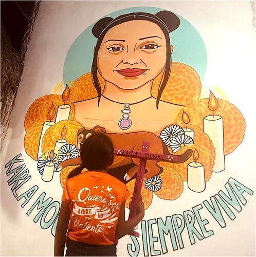 Figure 3. A young relative of the victim observes the mural she contributed to painting.