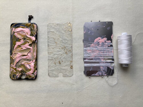 Figure 1. Touchscreen matter, touchscreen and acrylic paint, screensaver, goldleaf, back of touchscreen and white cotton thread (March 2021).