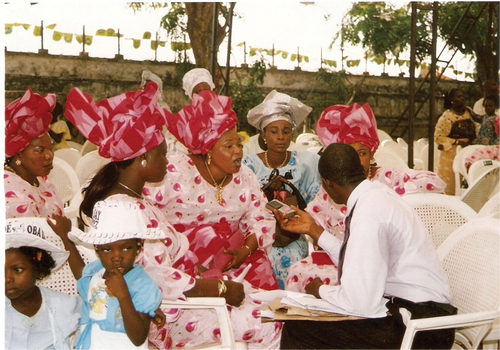 Figure 9. The researcher interviewing age-grade members during the 2007 event of Ojude-Oba festival.