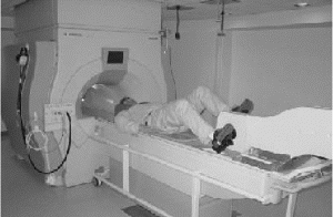 Figure 1. A subject pedaling the bicycle while lying supine on the scanner trolley.