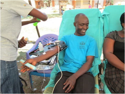 Photo 4. A youth donating blood during a community blood donation campaign.