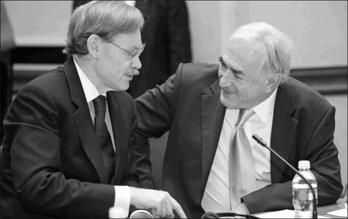 IMF managing director Dominique Strauss‐Kahn (R) and World Bank president Robert Zoellick (L) during the spring 2008 meetings of the IMF/World Bank at the IMF Headquarters in Washington, D.C. Prior to his election in 1998, Korean president Kim Dae‐Jung was pressured into signing a secret agreement “insuring South Korea's compliance with the terms of the IMF's structural adjustment program.” (Credit: IMF/Eugene Salazar)