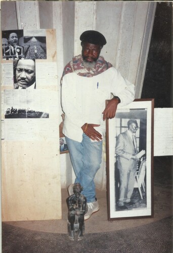 Figure 5. Gaspard Tatang at exhibition of his work leaning on a photograph of Cheikh Anta Diop.