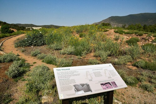Figure 1. Village trail sign, trail, and Mound A, facing west. Photo by MojiCinema, Albuquerque.
