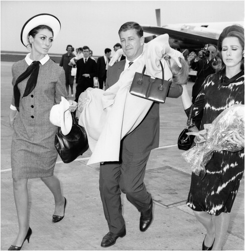 Figure 2. Australian Wool Board’s Tony Lewis carries Christine Borge at Melbourne’s Essendon Airport. Published in The Age, 26 October 1965. ID. FXB1430081 © Fairfax Photographic. Image reproduced with the permission of Fairfax Photographic.