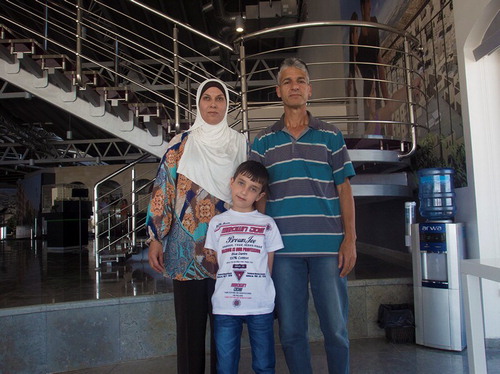 Figure 3  Abu Sami and his family in the Rawabi showroom (Photo: Author).